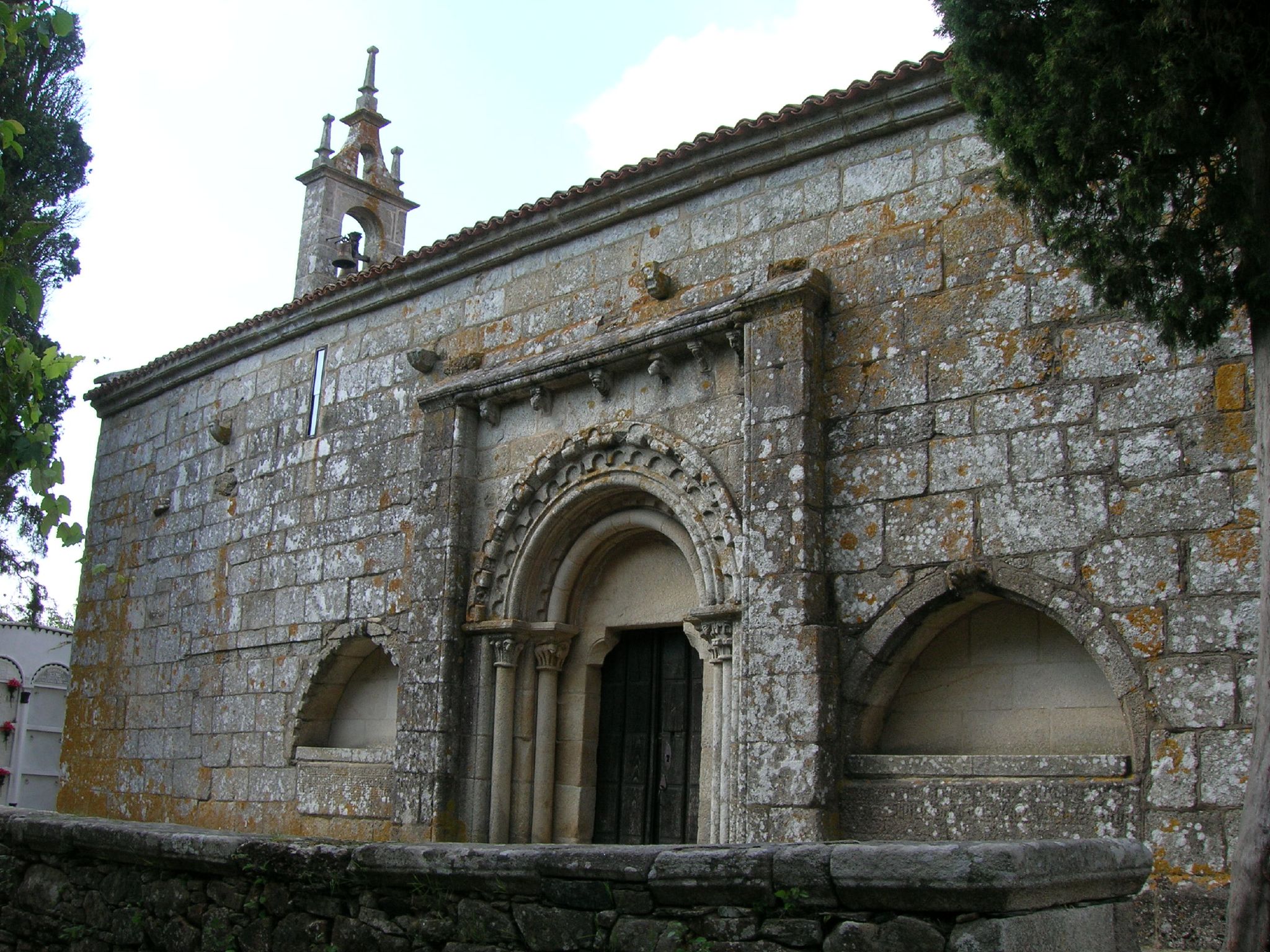 a church with many arches and windows is made of rock