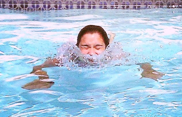 a woman swimming in a pool in the water