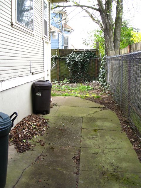 a back side walk leading to an enclosed yard
