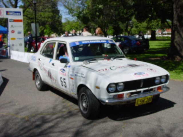 an old car with rally numbers painted on the side