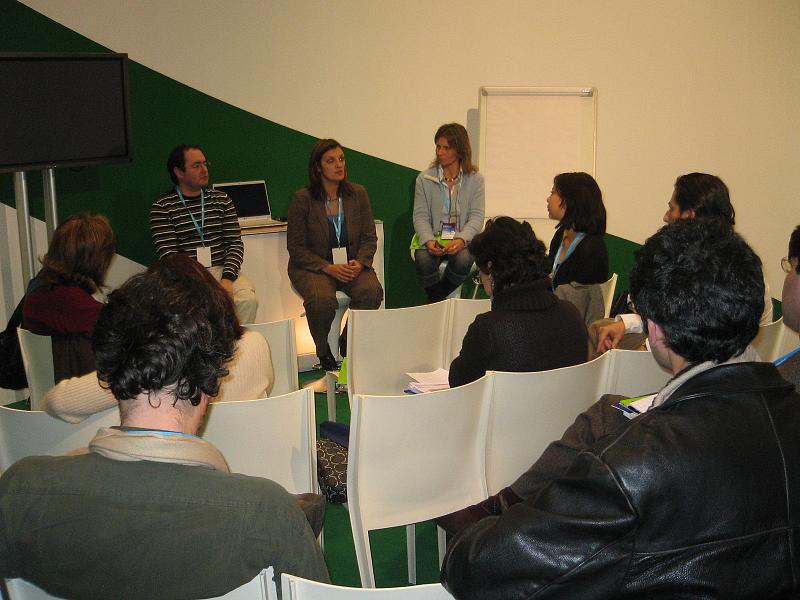 group of people sitting in a room around each other