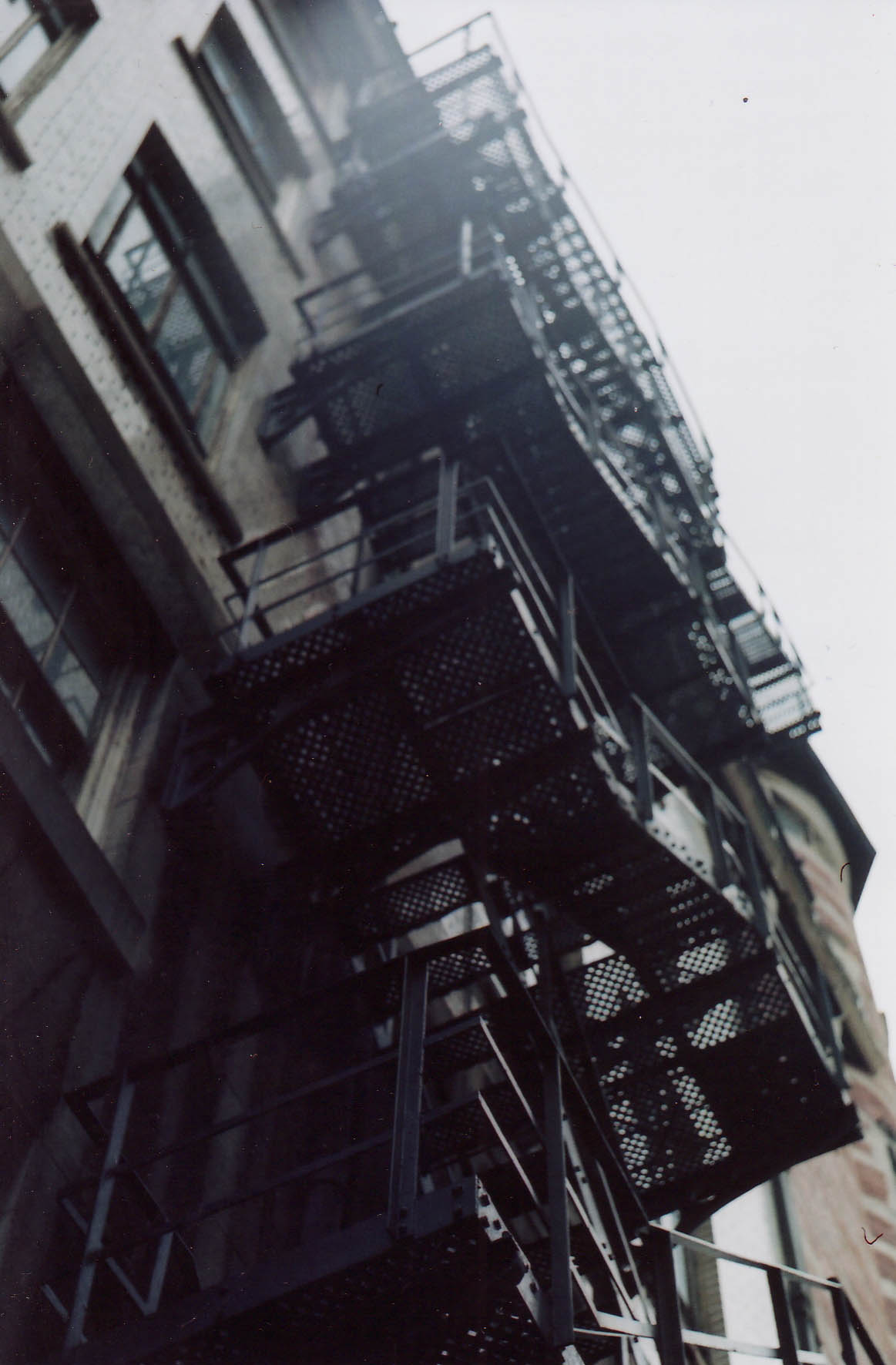 the fire escapes in the building are black and white