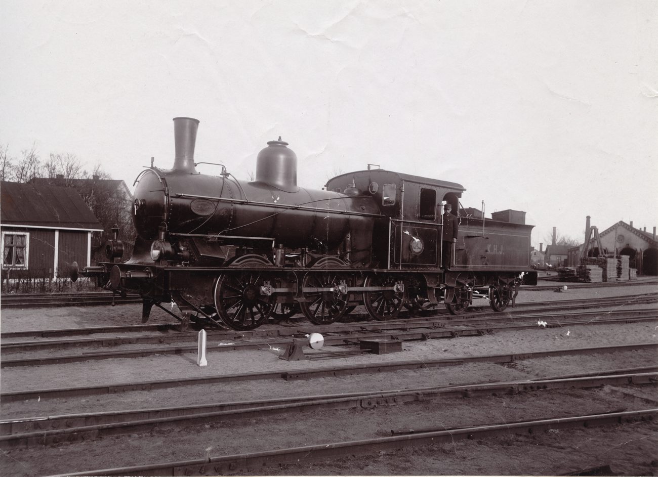a black and white image of an old train on train tracks