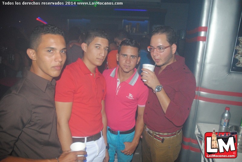 four men are posing with each other drinking