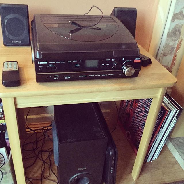 a table with many electronics and a stereo