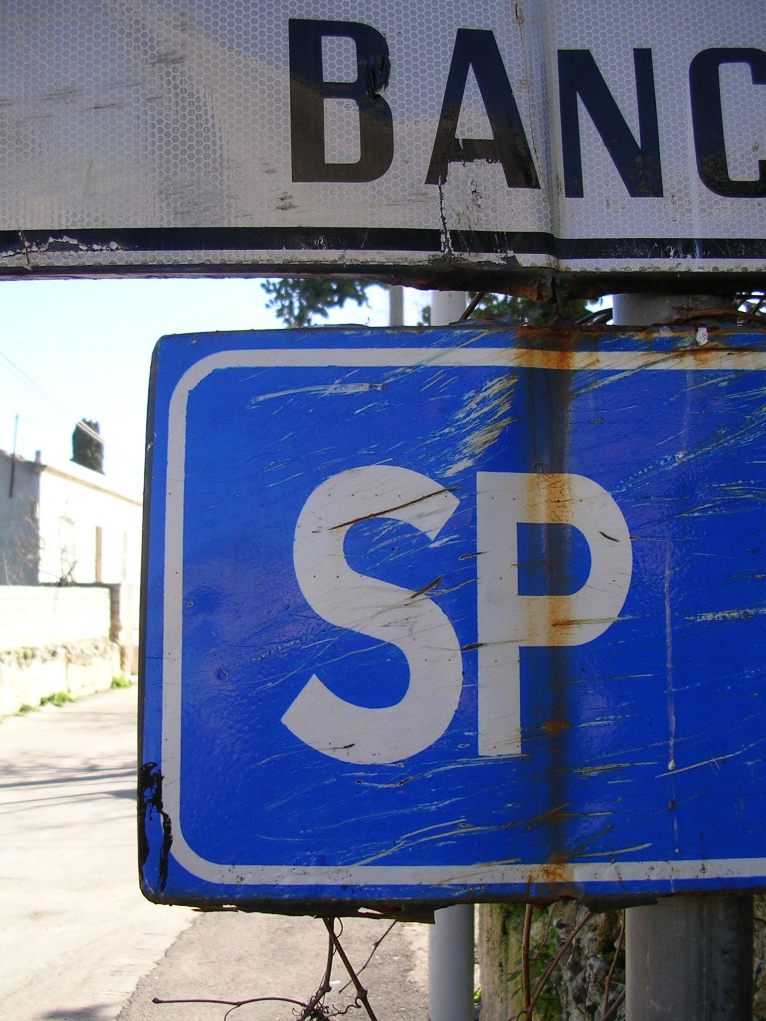 street sign saying banc with trees in background