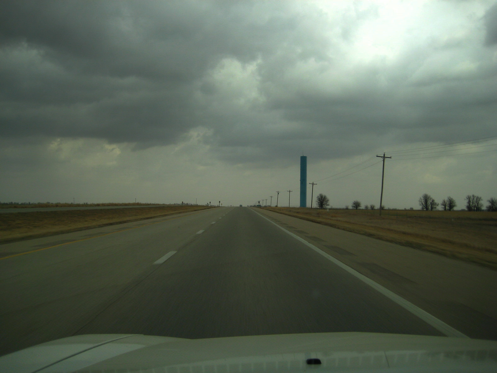 a dark stormy sky over an open highway