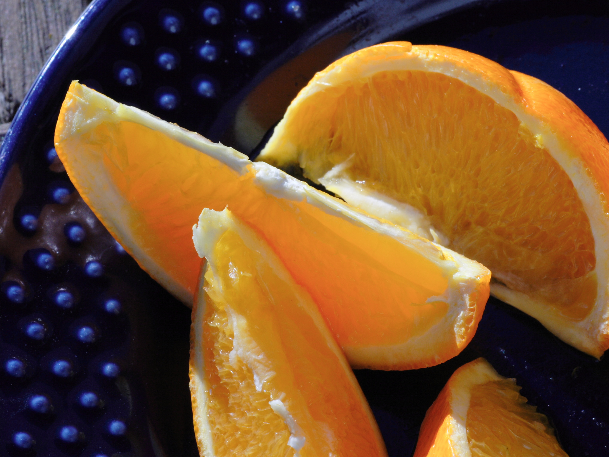 peeled oranges sitting on top of a blue dish