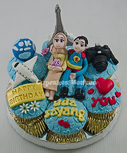 a happy birthday cake with two small figurines on top