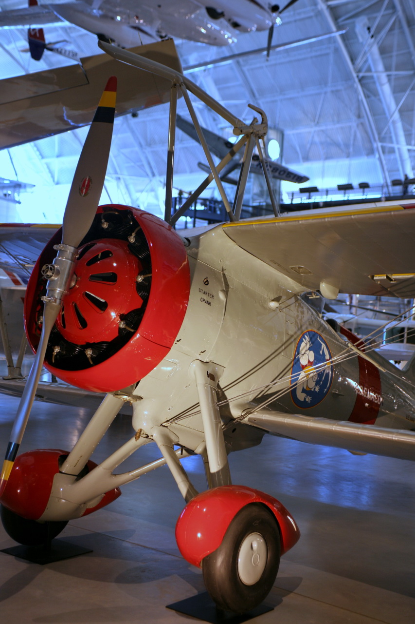 small old fashioned airplane on display in a museum