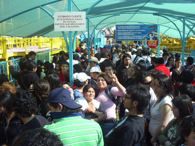 a large group of people standing around near a train station