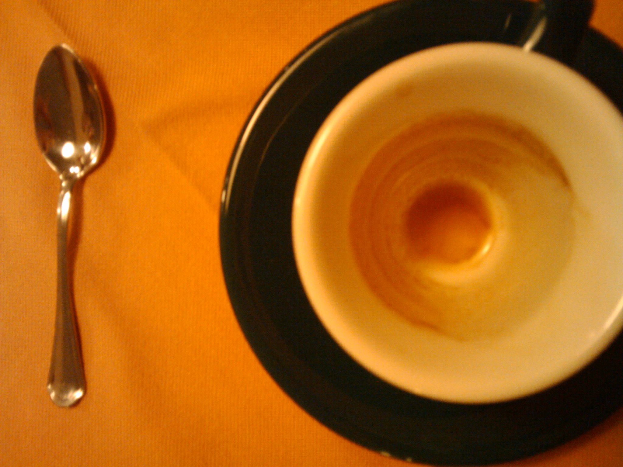 a bowl of food with a spoon and knife