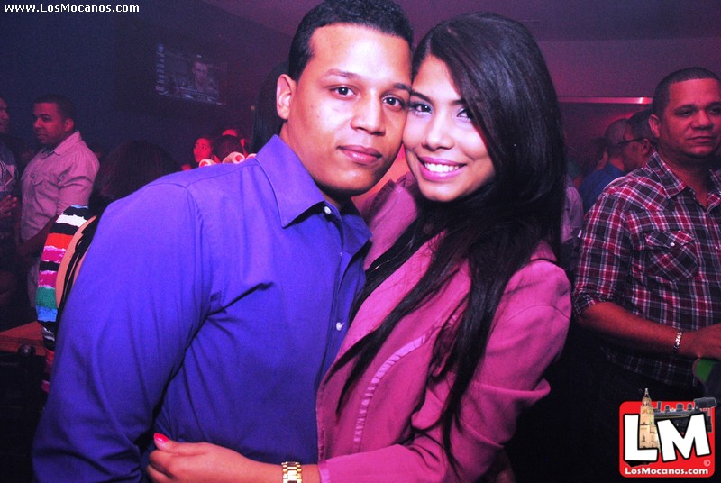 two people posing for a po at a club