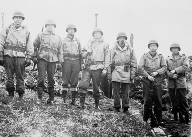 black and white pograph of men wearing uniforms