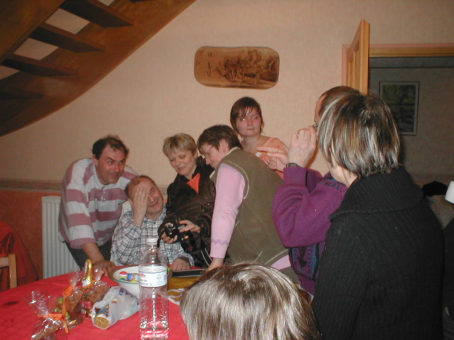 a group of people are gathered around a table