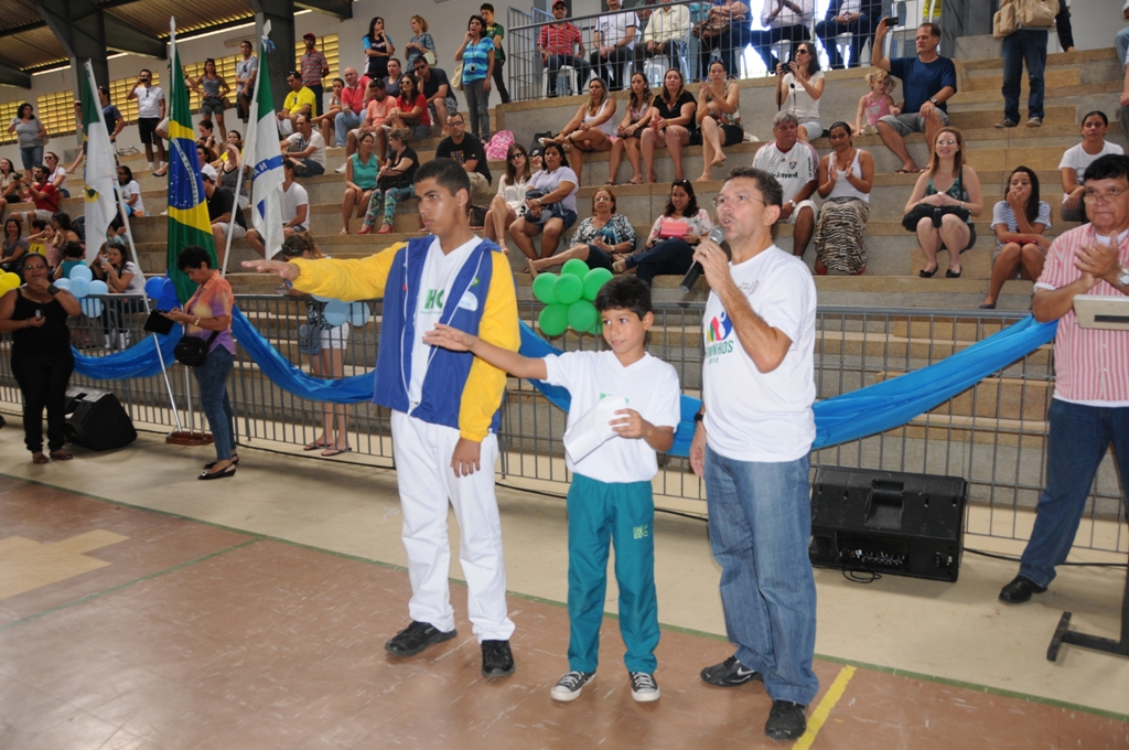 a crowd of people watching two men perform a dance with a ribbon