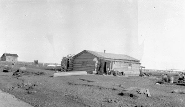 a black and white po shows the old cabin and truck