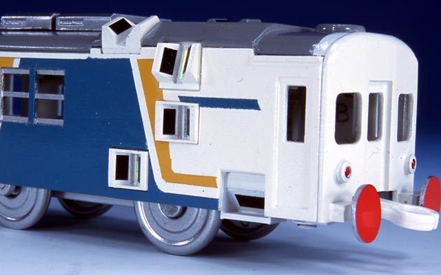 toy truck model with white exterior, orange sides and blue