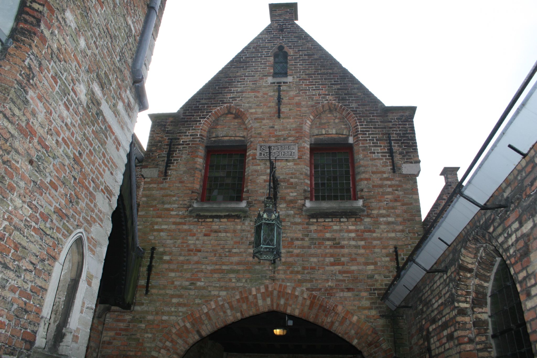 the entrance to an alley way with arched doorways