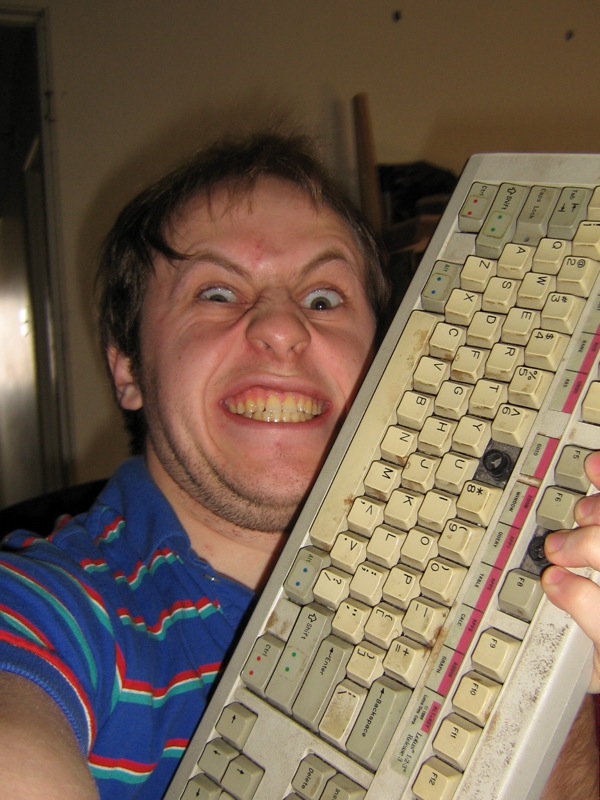 a man holds up a very old fashioned keyboard