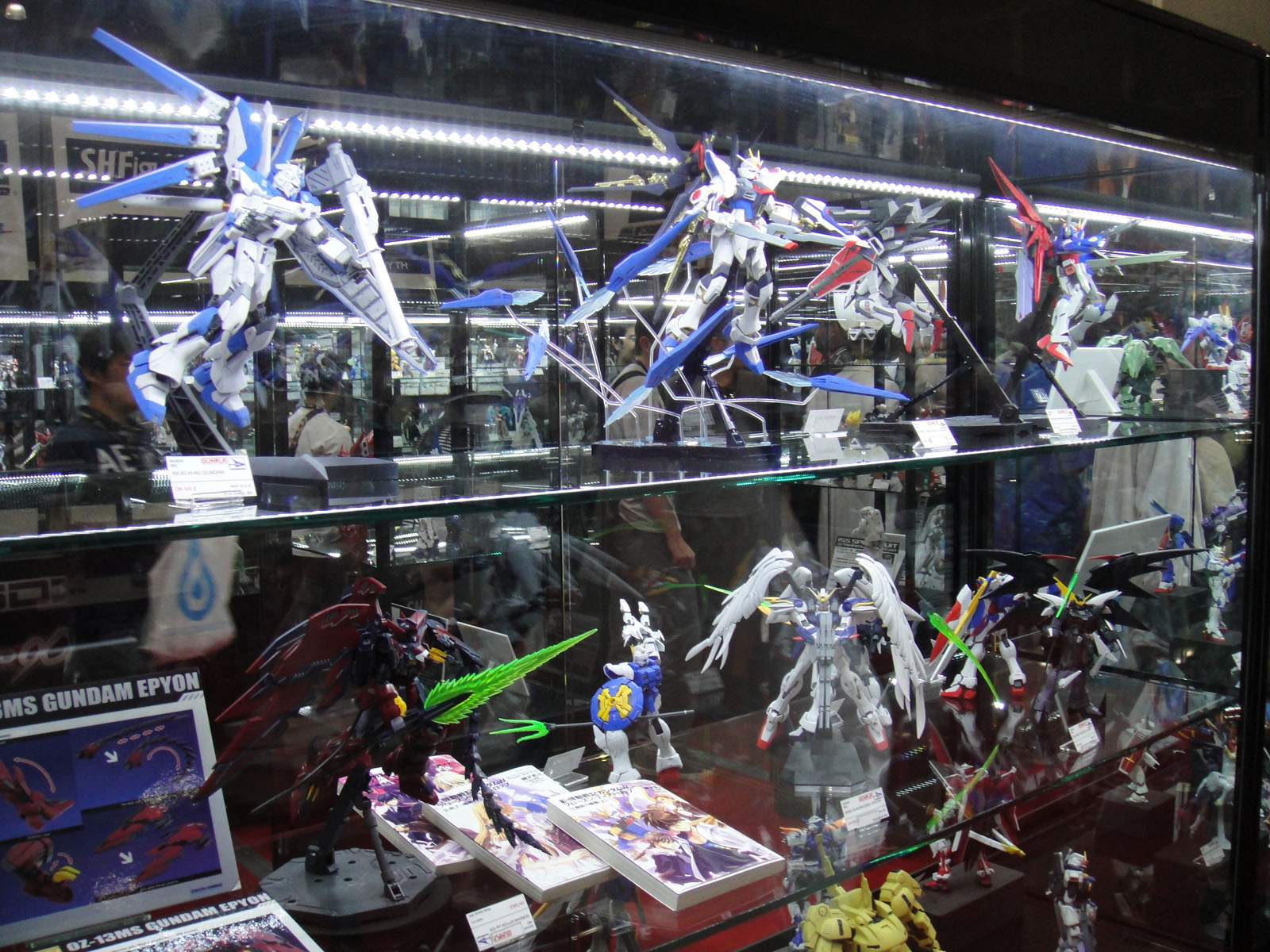 a glass case holds various anime action figures