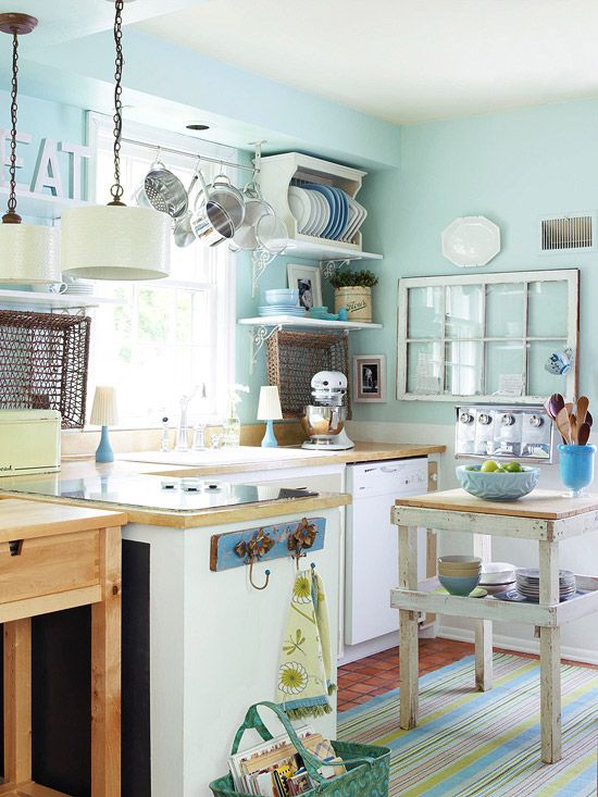 this kitchen has blue walls and white cabinets