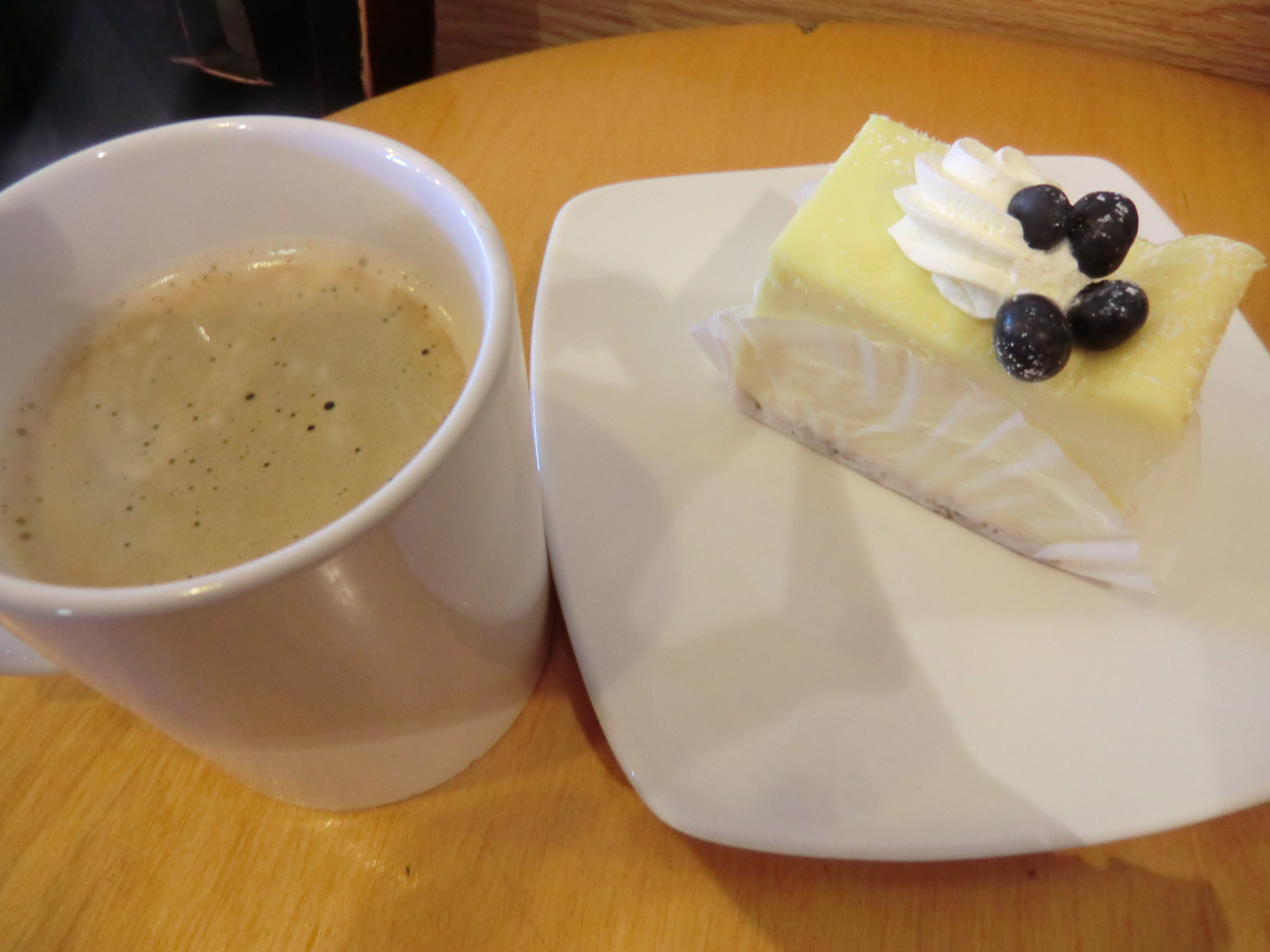 a cup and a plate with dessert on it