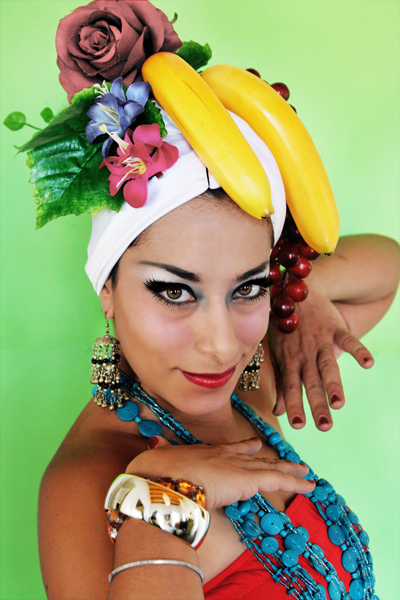a woman wearing a headband made of bananas, gs, leaves and other plants