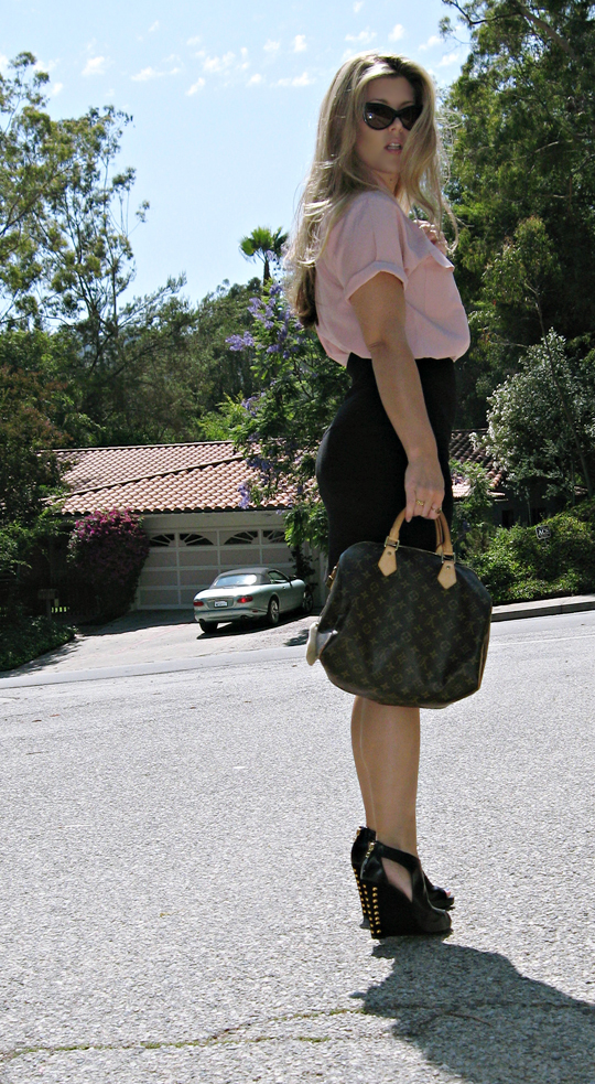 a blond woman walking down the street holding her purse