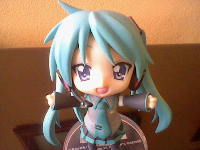 a cartoon figurine stands with a round disk