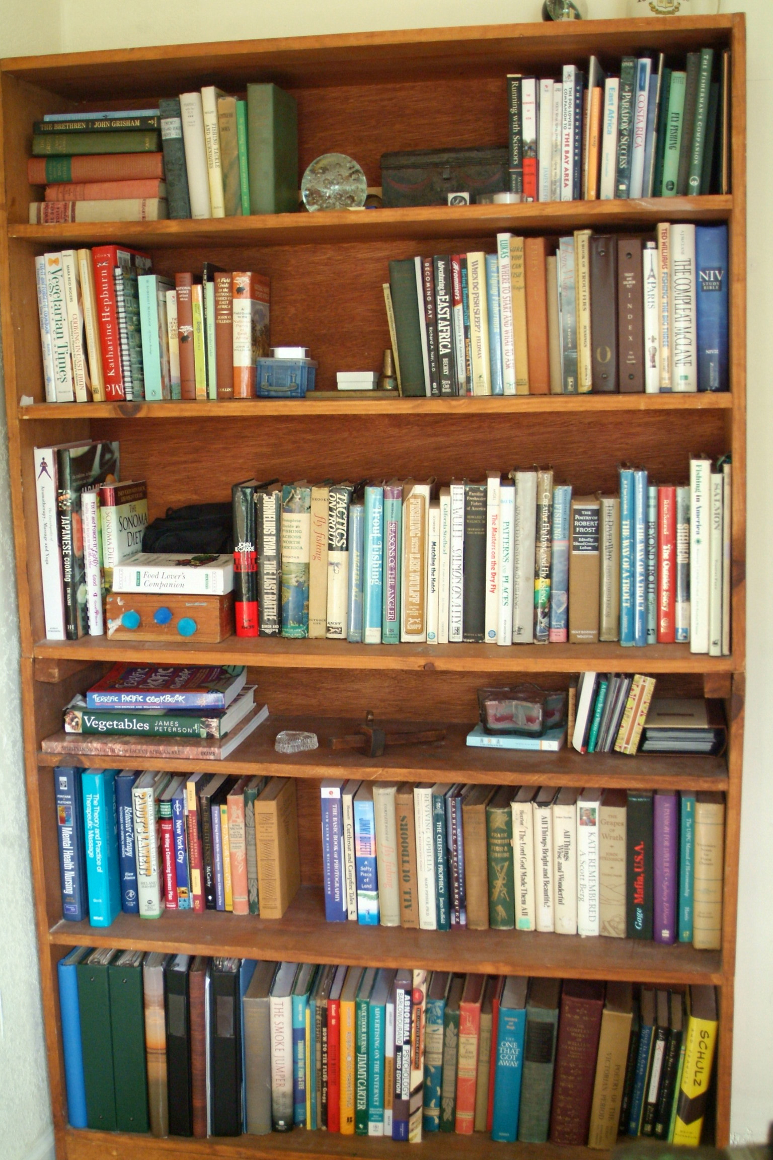 a tall bookcase filled with books in a living room