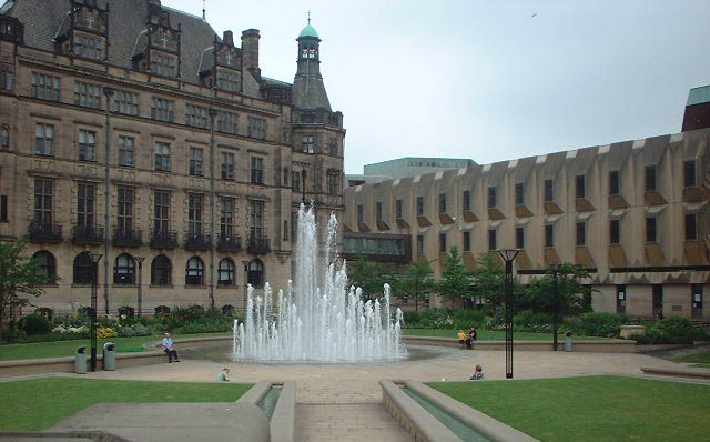 a large building and fountains in the center of it