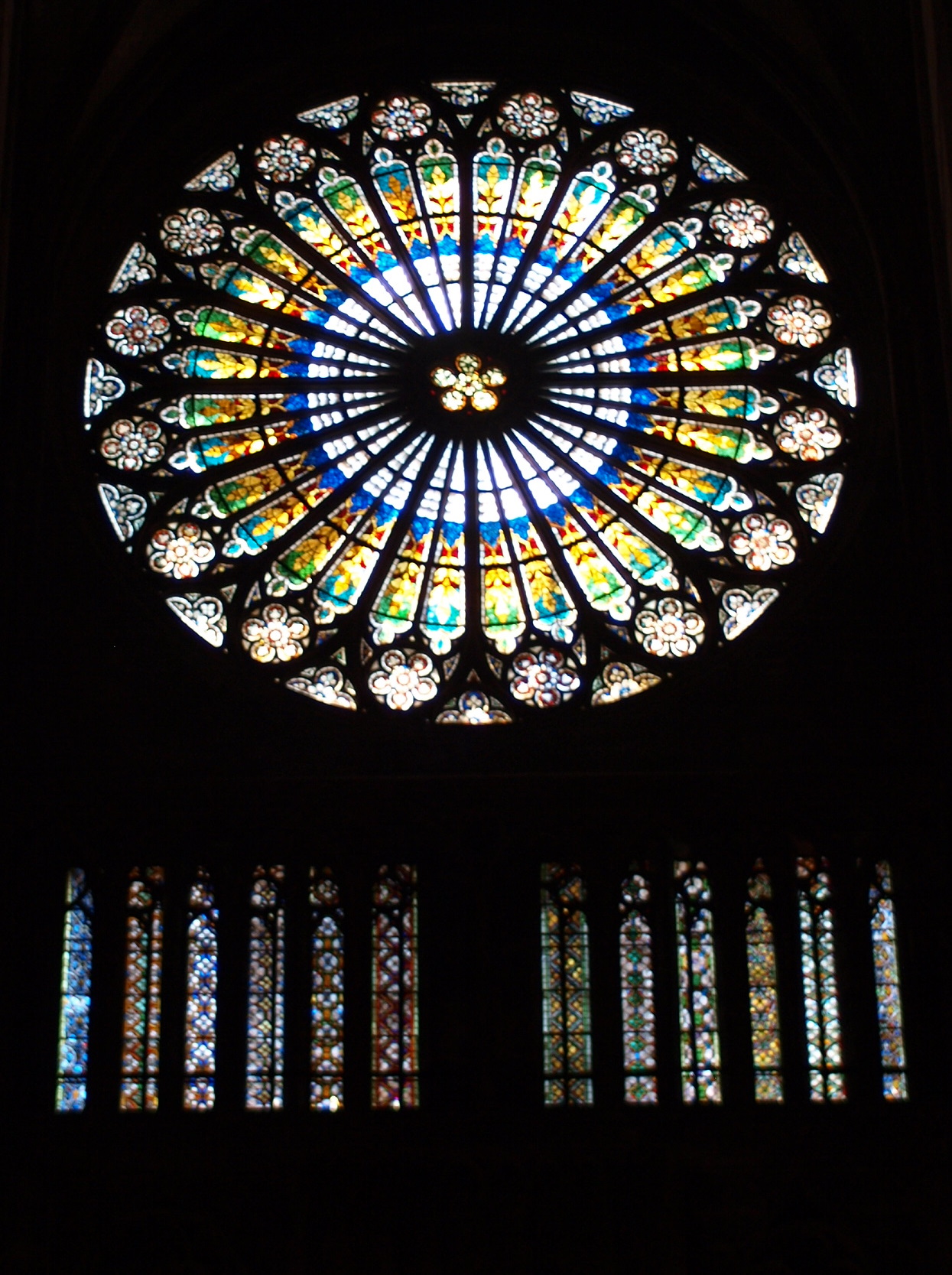 a large stained glass window in a cathedral