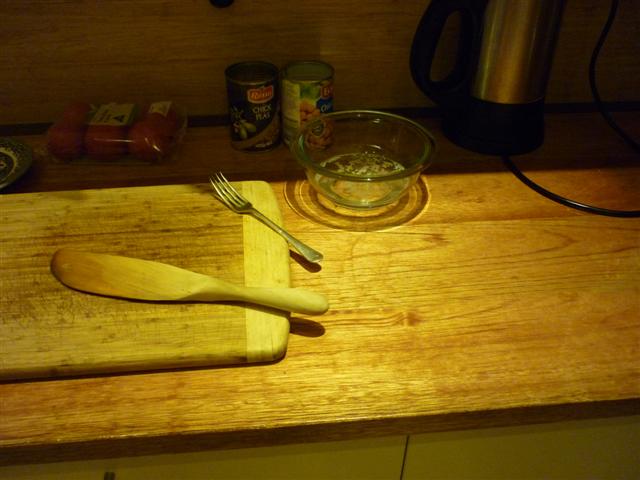 a wooden  board sitting on top of a kitchen counter
