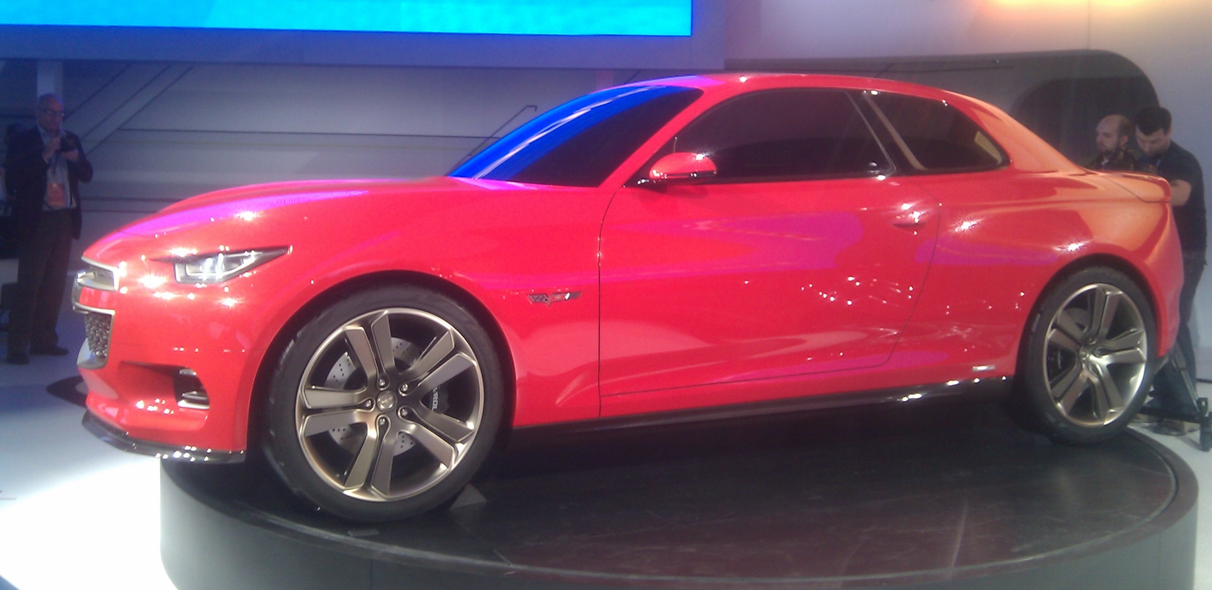 a red sports car that is sitting on display