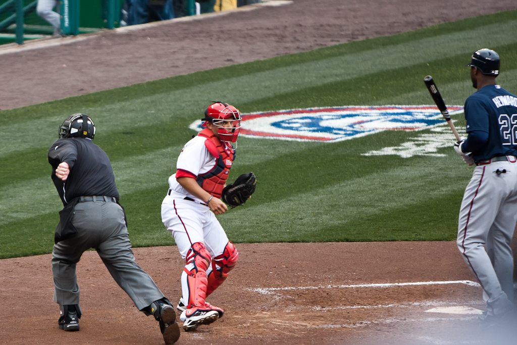 there are three baseball players standing at the field