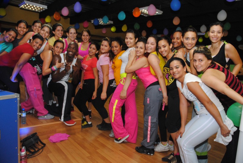 a group of woman wearing sports wear posing for a picture