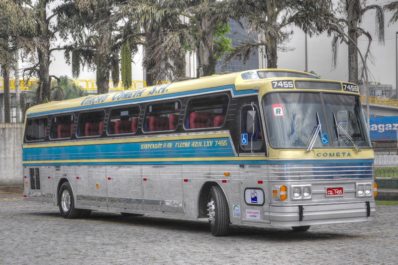 a large silver bus parked on the street