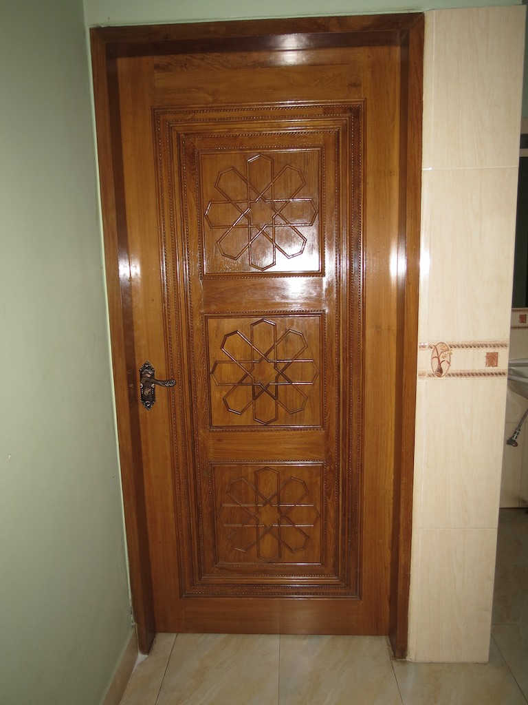 a wooden door with decorative carving on it