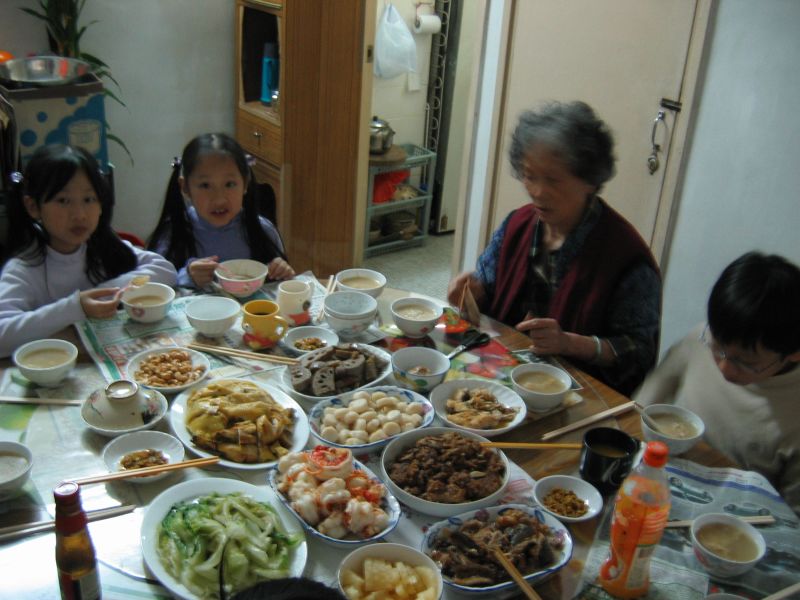 a table full of dishes of food for family dinner