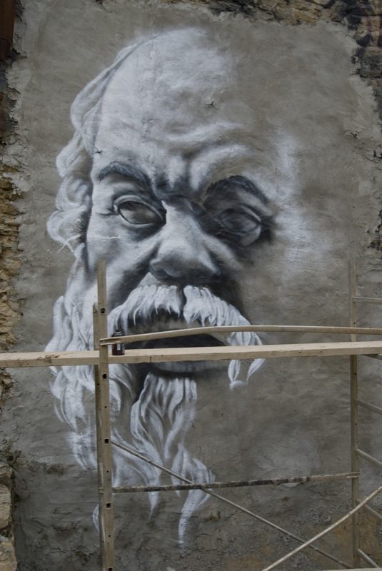 a picture of the face of a man that appears to have been painted on a wall