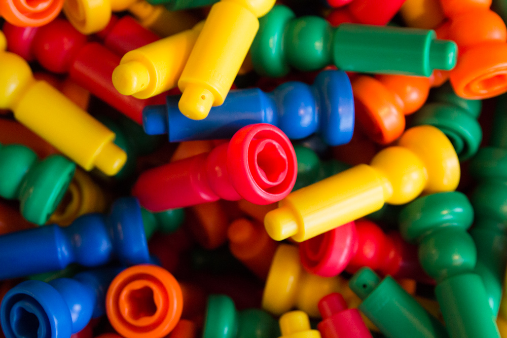 the many toy items are colorfully arranged in rows