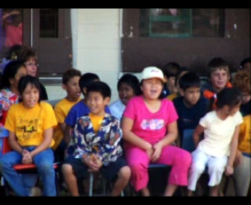 children sitting in front of the school waiting to be answered