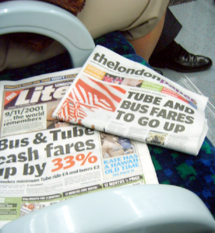 news paper and toilet paper sitting on a floor