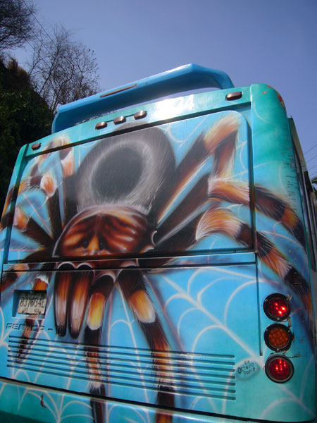 a bus with a giant spider painted on the side