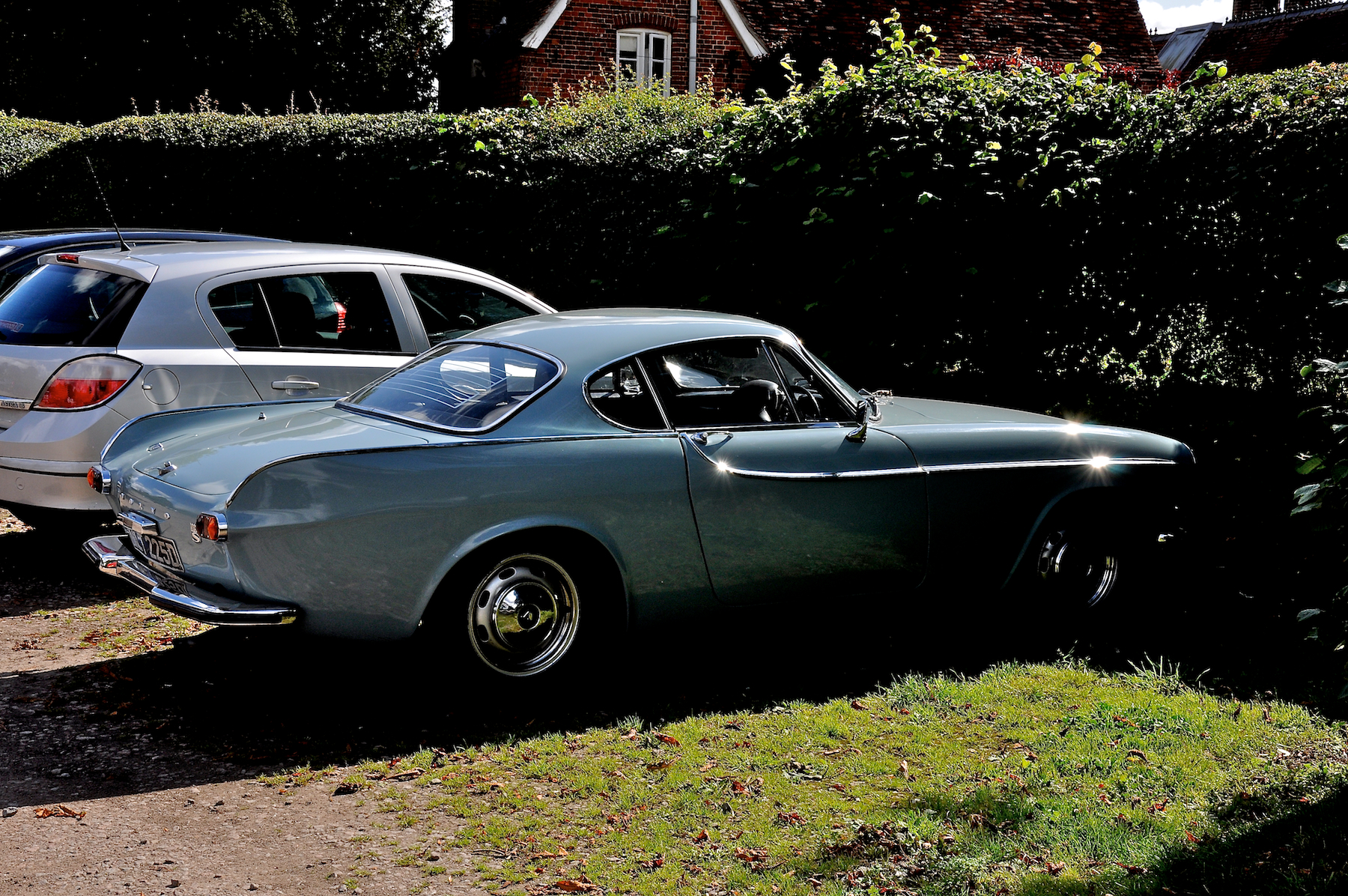 two cars parked side by side in the grass