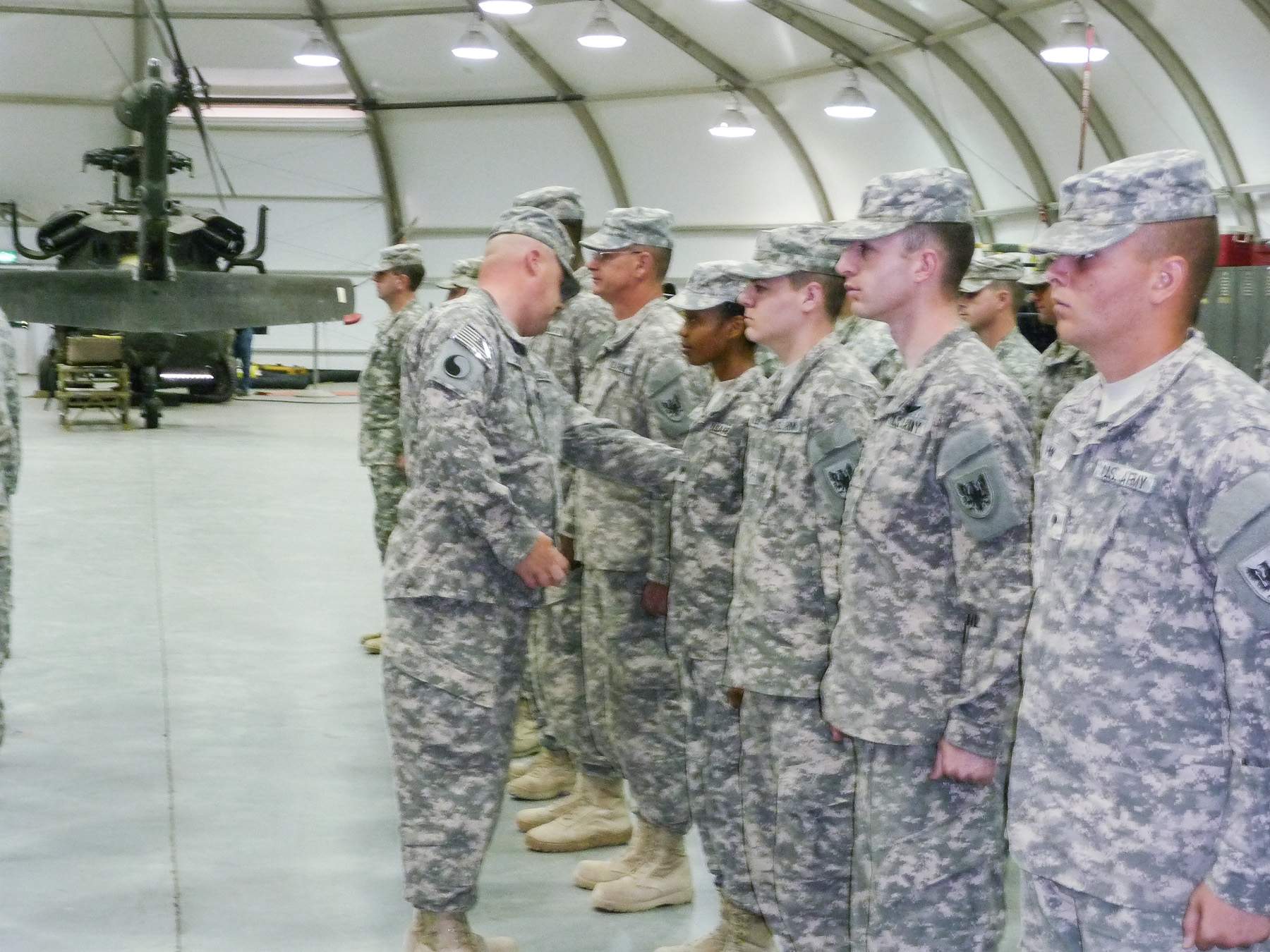 soldiers are standing around each other while shaking hands