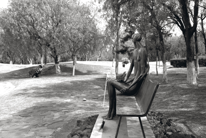 a man sitting on top of a park bench