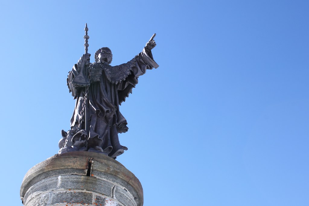 a statue of a person pointing up