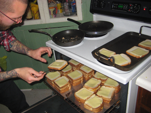 a man pulls out bread from the oven to cook